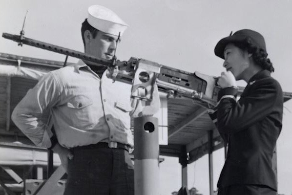 Navy Ensign Susan Ahn Cuddy instructs a sailor on how to fire a .50-caliber machine gun at Naval Air Station Pensacola, Fla.