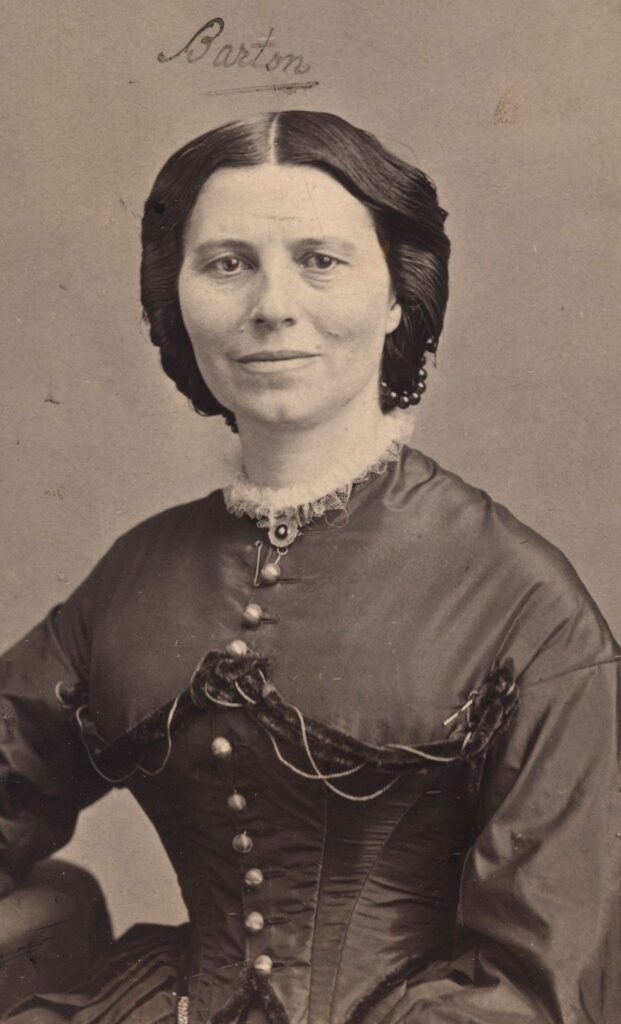 Portrait photograph of Clara Barton seated in dark clothing during the Civil War era, looking directly at the camera with a composed expression