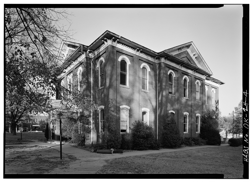 A two-story brick government building with a central cupola, the Cherokee National Capitol in Tahlequah.